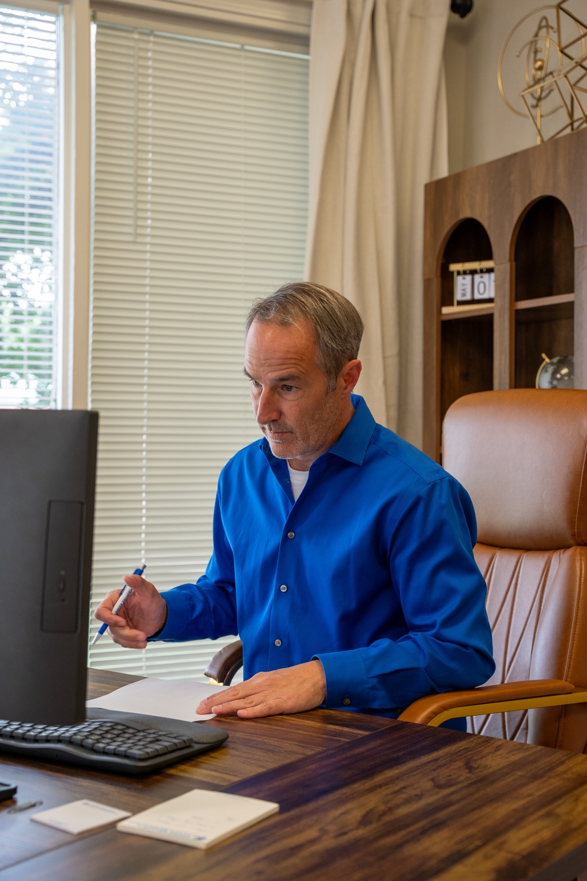 Wade Wright reviewing exchange documents at his desk