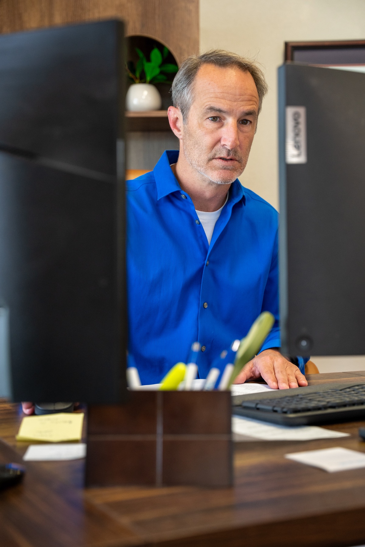 Wade Wright working at his desk in the Fayetteville office